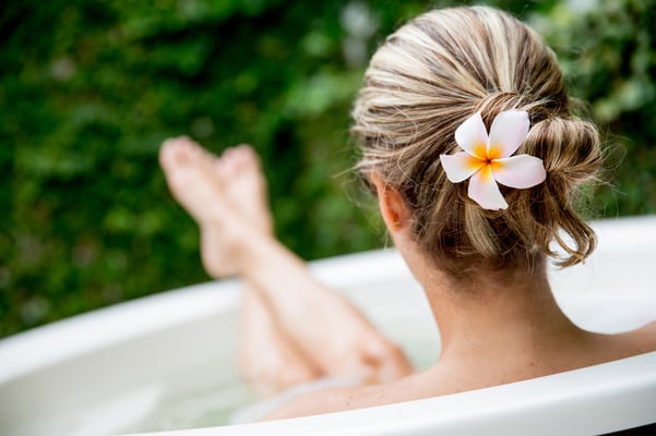 Beautiful woman relaxing at home and taking a bath